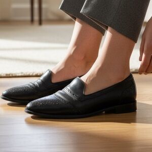 Aigner black leather slip on shoes.